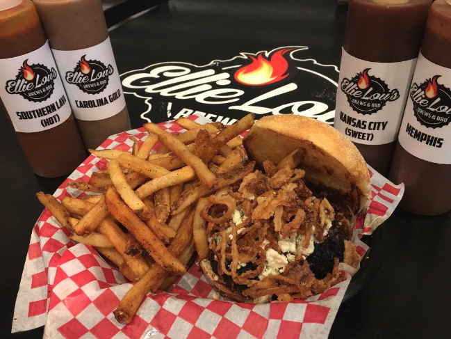 bbq sandwich with fries and sauce bottles